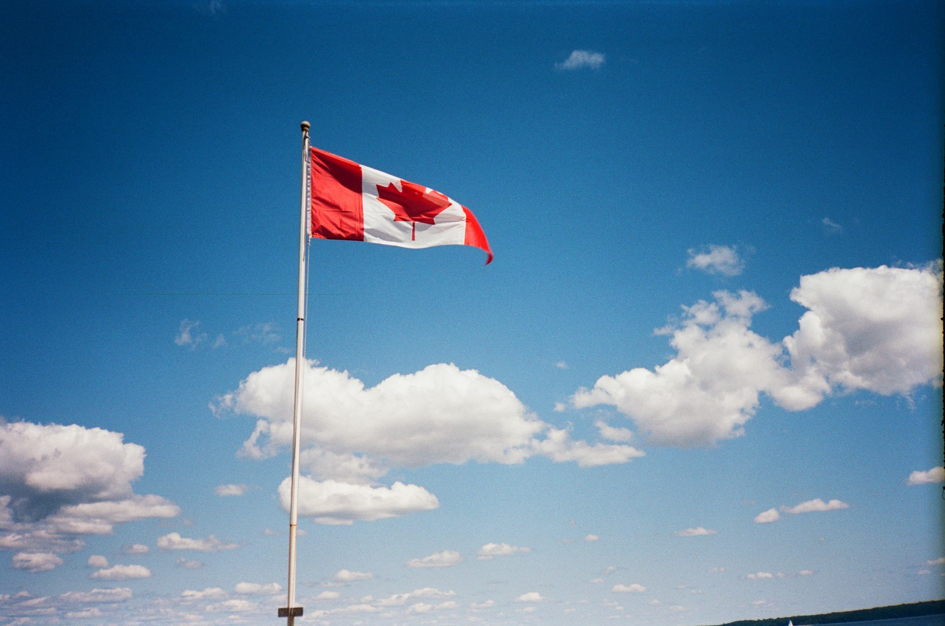 Canadian flag against blue sky